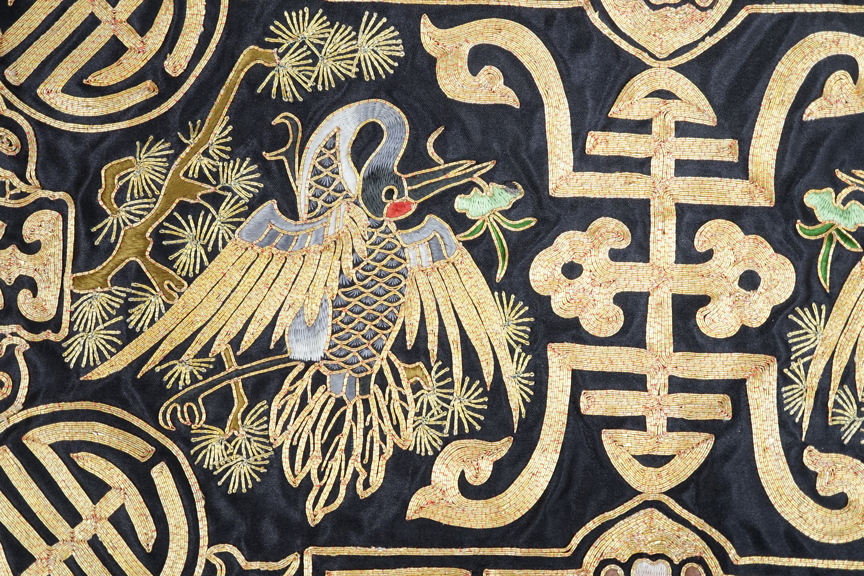 A Chinese silk textile phoenix panel embroidered with gold thread, 45cm x 25cm